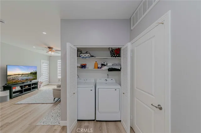 a kitchen with a table chairs and wooden floor