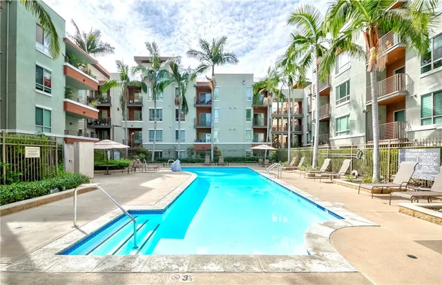 a swimming pool with outdoor seating and yard