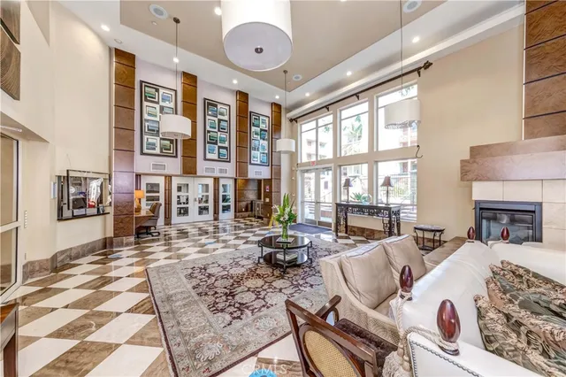 a living room with fireplace furniture and a rug