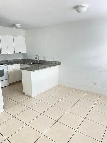 a view of a kitchen with white cabinets
