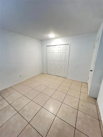 a view of an empty room and a window