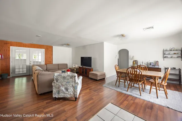 a living room with furniture a table and a flat screen tv