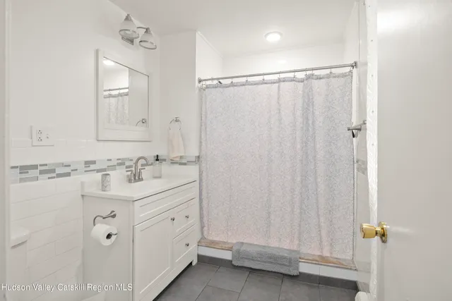 a bathroom with a double vanity sink and mirror