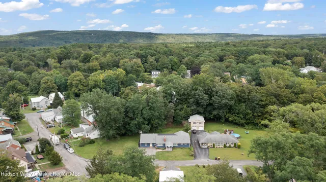 a view of a house with a yard and lake view