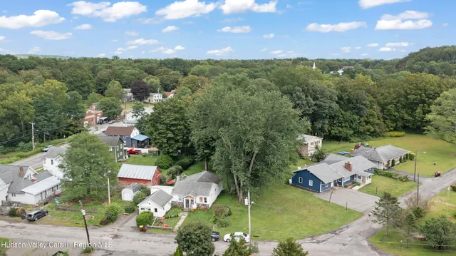 an aerial view of residential houses with outdoor space and street view
