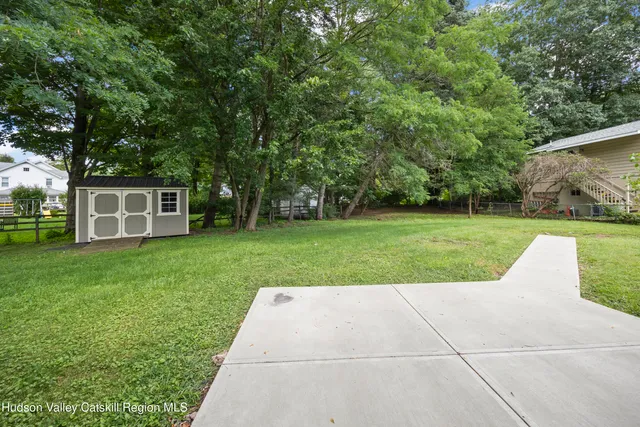 a view of a backyard with a garden and entertaining space