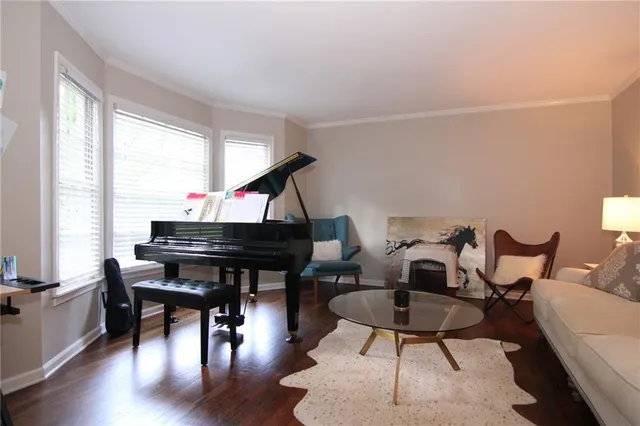 a living room with furniture a piano and a window