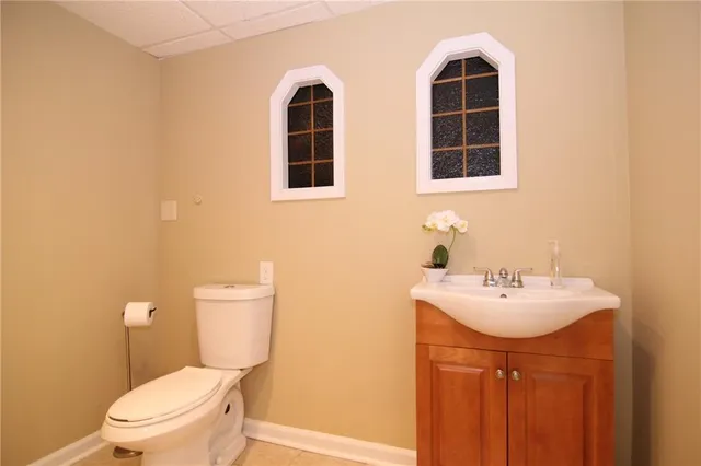 a bathroom with a sink a toilet and a mirror