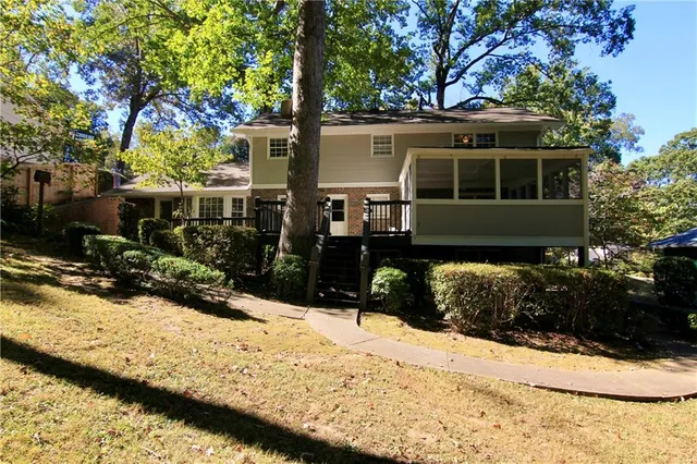 a view of a house with snow on the side of the road