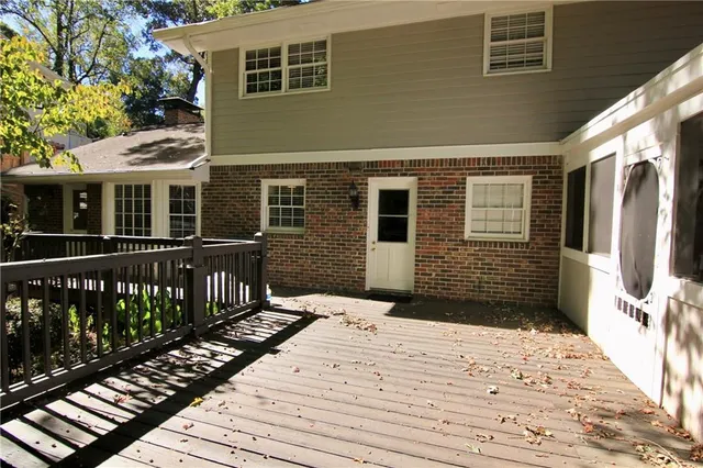 a view of a house with wooden deck