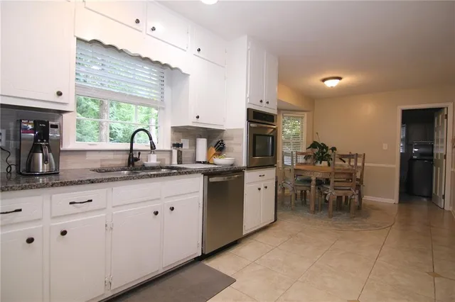 a kitchen with sink cabinets and window