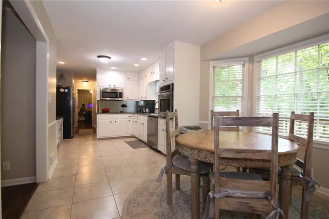 a kitchen with a table and chairs