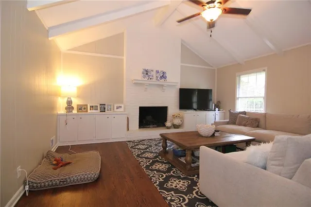 a living room with furniture fireplace and flat screen tv