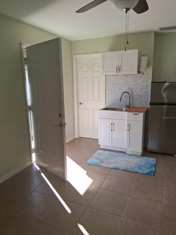 a kitchen with stainless steel appliances granite countertop a refrigerator a sink and a stove