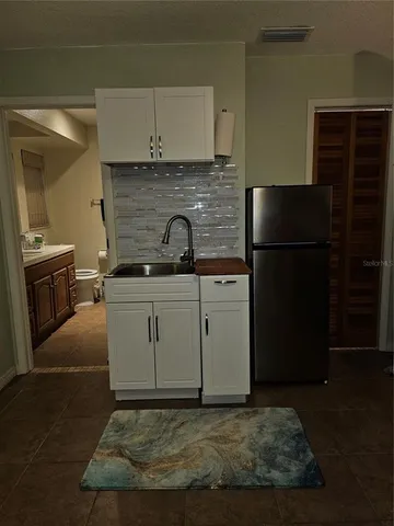 a kitchen with a sink stove and refrigerator