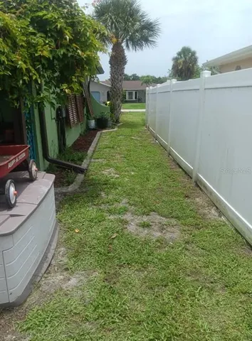 a view of a chairs and table in a backyard