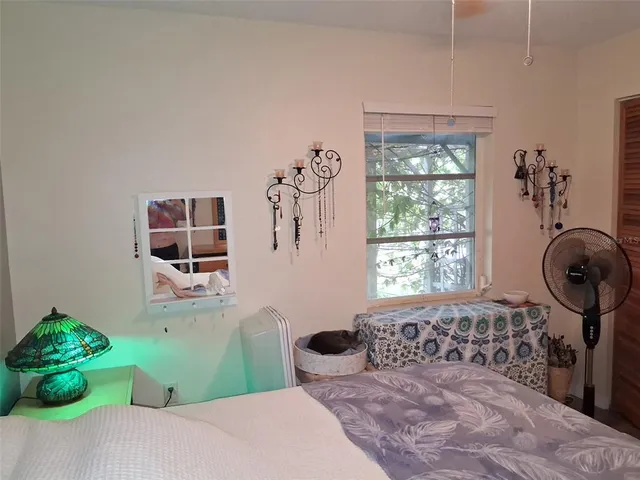 a bedroom with a bed and a window