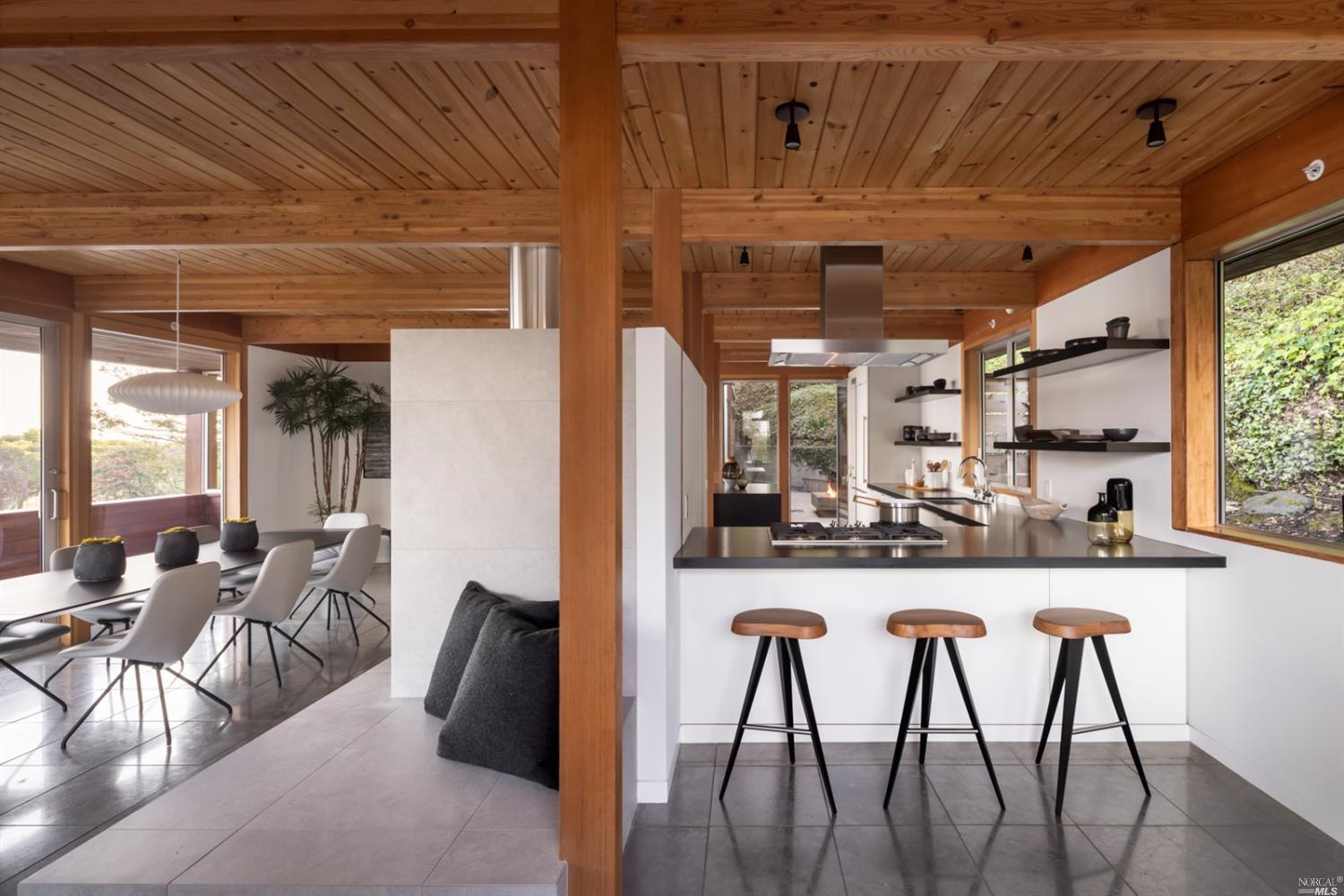 121 Toyon Lane Sausalito, CA 94965 - Photo 3 of 25 a kitchen with stainless steel appliances kitchen island granite countertop a table chairs in it and wooden floor