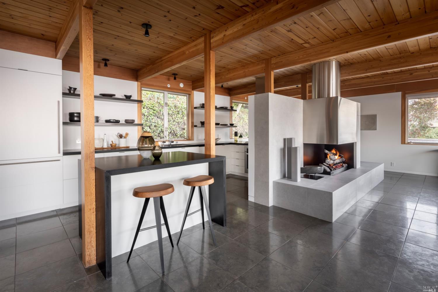 121 Toyon Lane Sausalito, CA 94965 - Photo 7 of 25 a kitchen with stainless steel appliances granite countertop a refrigerator a sink dishwasher a dining table and chairs with wooden floor