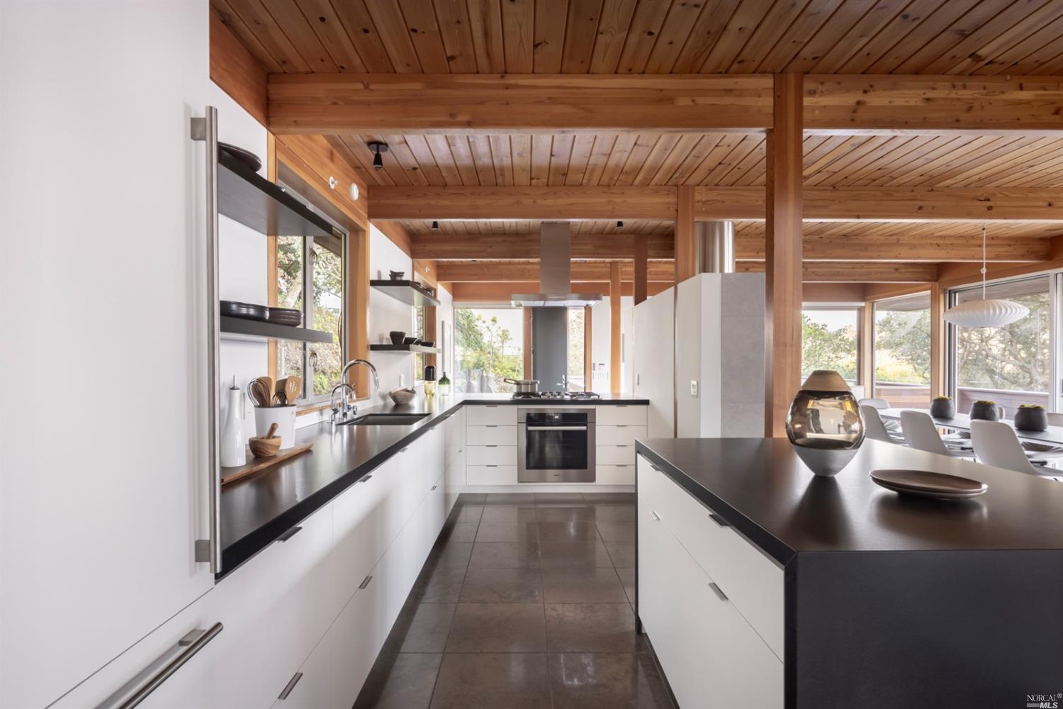 121 Toyon Lane Sausalito, CA 94965 - Photo 8 of 25 a large kitchen with kitchen island a large window a sink and stainless steel appliances