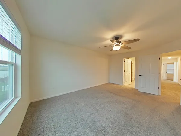 a view of a livingroom with a ceiling fan and window