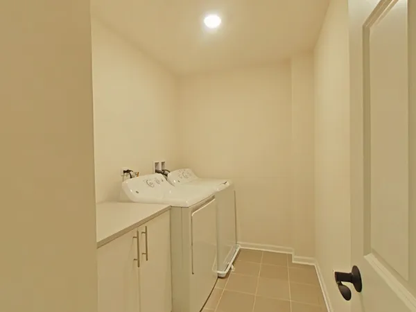 a utility room with a sink and dryer