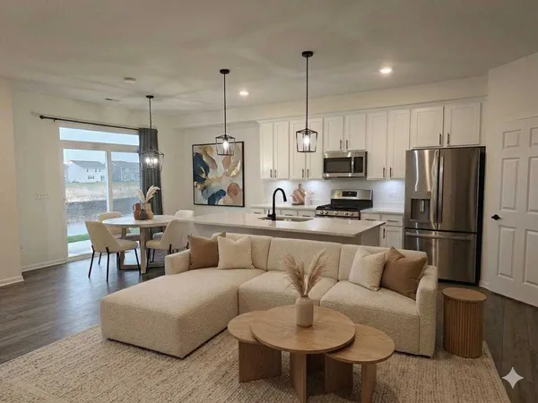 a living room with furniture flat screen tv and outdoor view