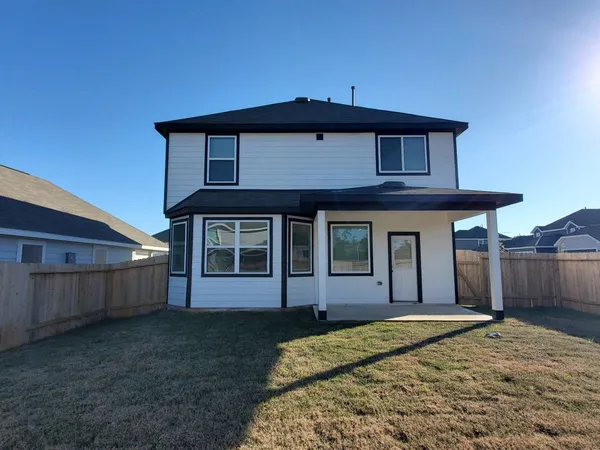 a living room with furniture and a book shelf