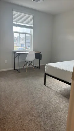 a bathroom with a granite countertop bathtub sink vanity mirror and toilet