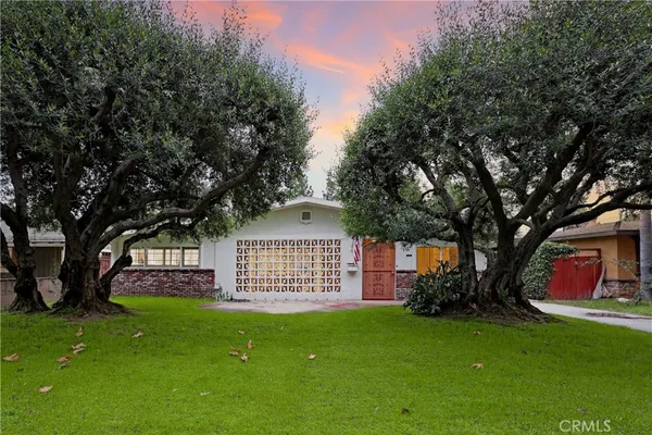 a view of an house with backyard space and garden