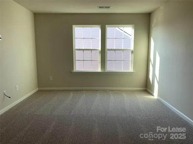an empty room with a empty space and windows