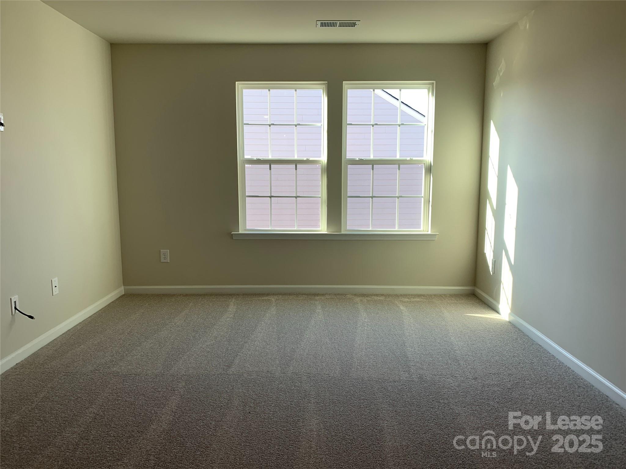 17212 Snug Harbor Drive Charlotte, NC 28278 - Photo 11 of 16 an empty room with a empty space and windows