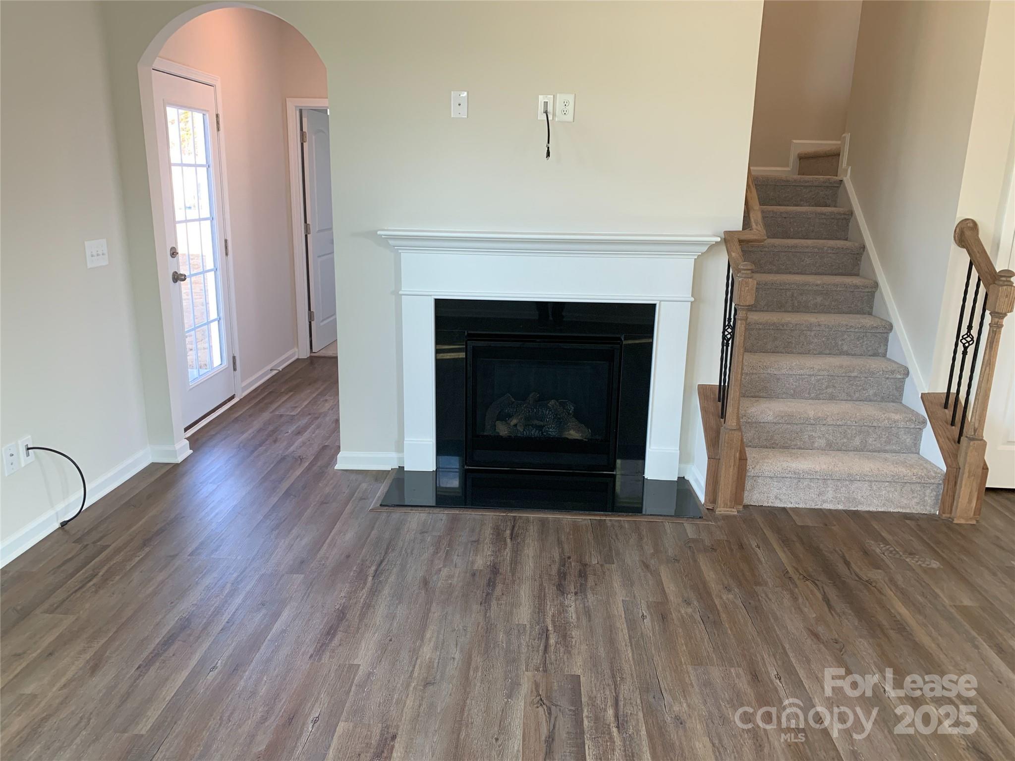 17212 Snug Harbor Drive Charlotte, NC 28278 - Photo 5 of 16 a view of a livingroom with wooden floor and a fireplace