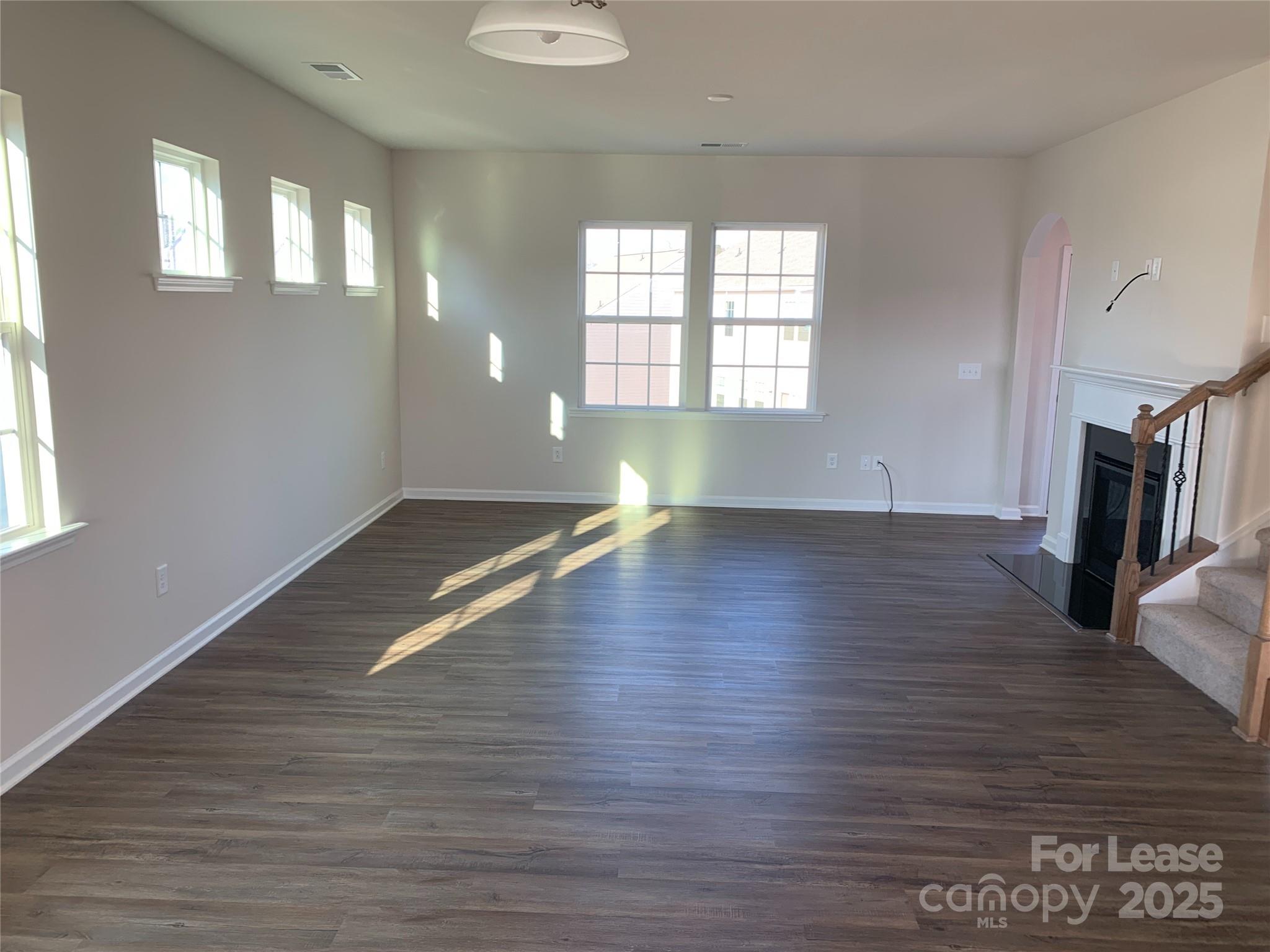 17212 Snug Harbor Drive Charlotte, NC 28278 - Photo 6 of 16 an empty room with wooden floor and windows