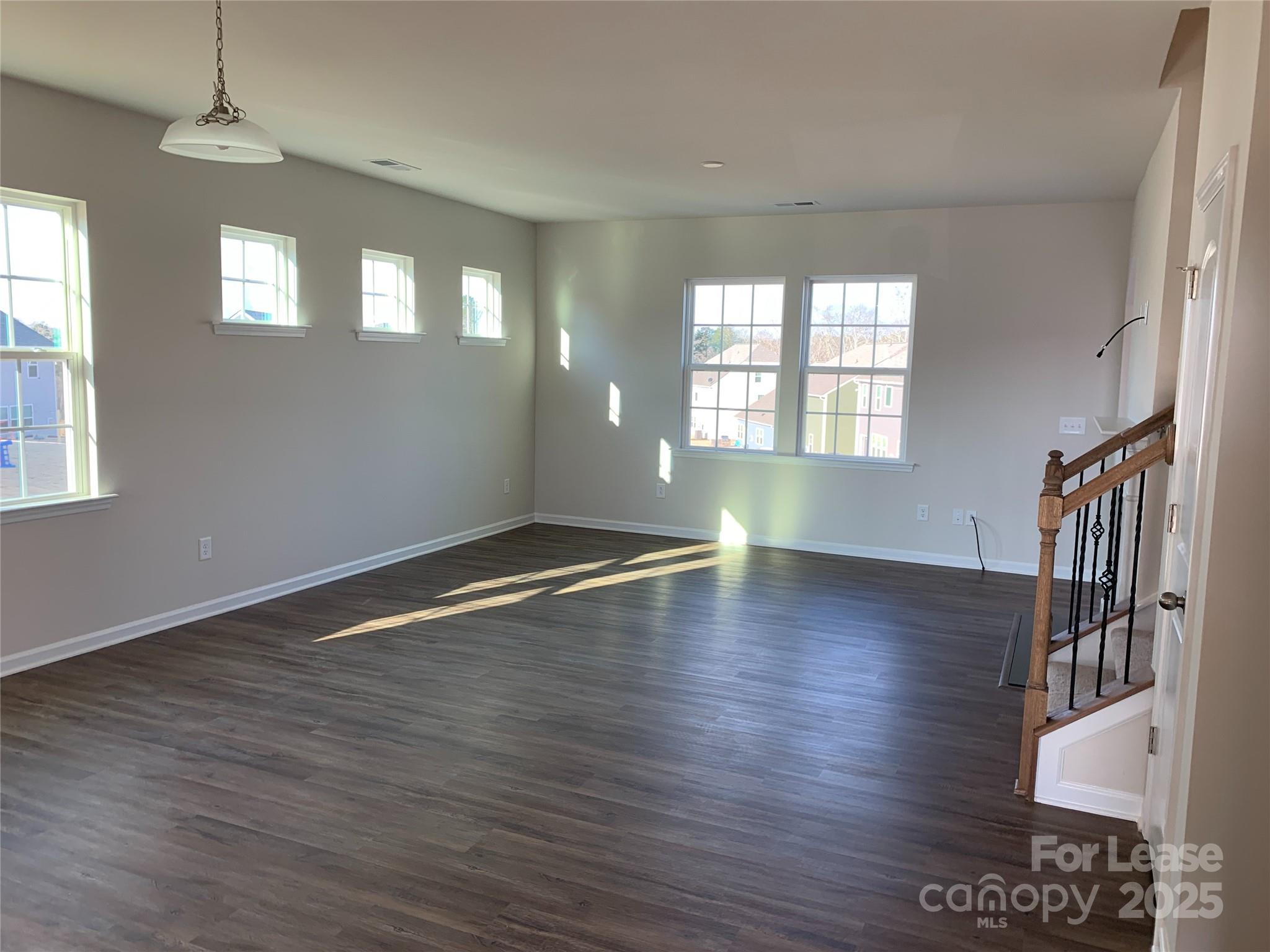 17212 Snug Harbor Drive Charlotte, NC 28278 - Photo 10 of 16 an empty room with wooden floor and windows