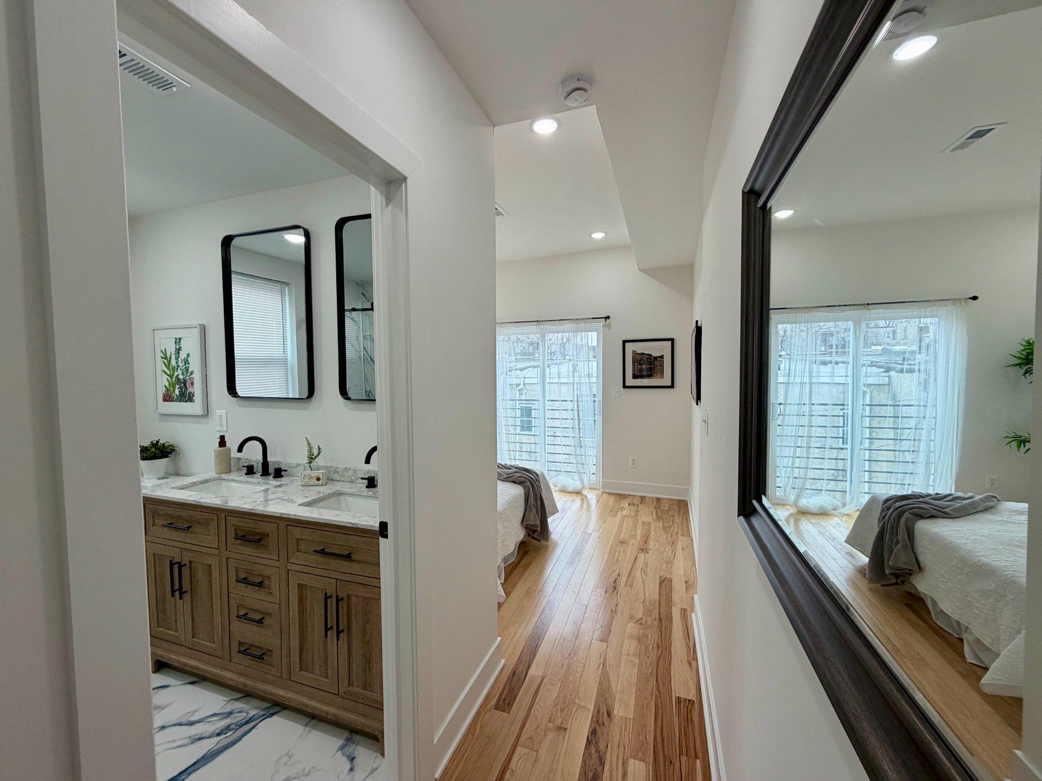 1314 South 46th Street Philadelphia, PA 19143 - Photo 23 of 56 a spacious bathroom with a double vanity sink a mirror and a bathtub