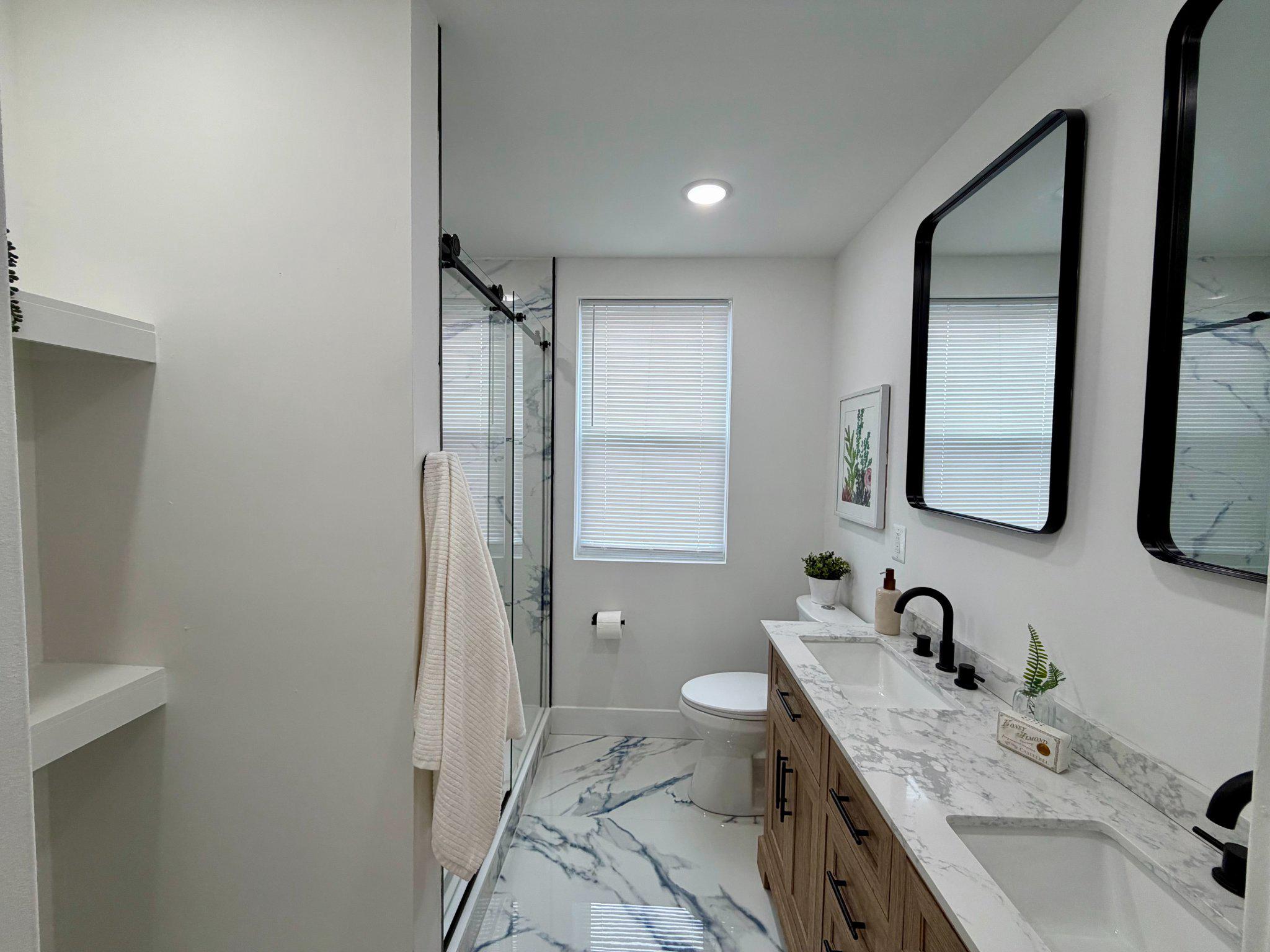 1314 South 46th Street Philadelphia, PA 19143 - Photo 25 of 56 a bathroom with a granite countertop sink toilet and mirror