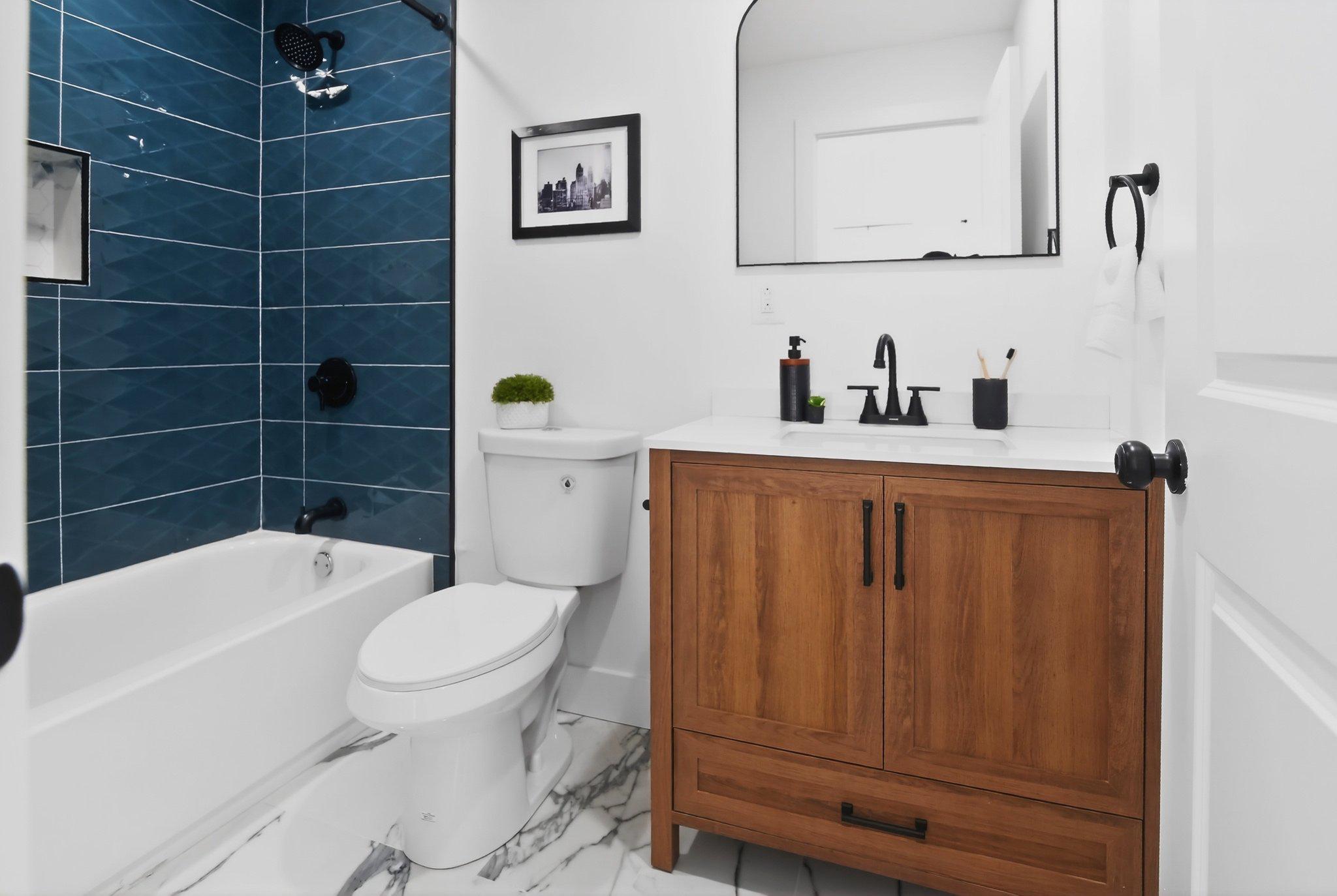 1314 South 46th Street Philadelphia, PA 19143 - Photo 34 of 56 a bathroom with a toilet a sink and bathtub