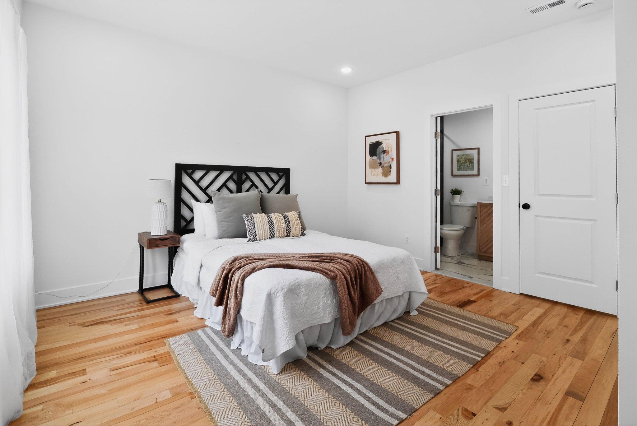 1314 South 46th Street Philadelphia, PA 19143 - Photo 41 of 56 a bedroom with a bed and wooden floor
