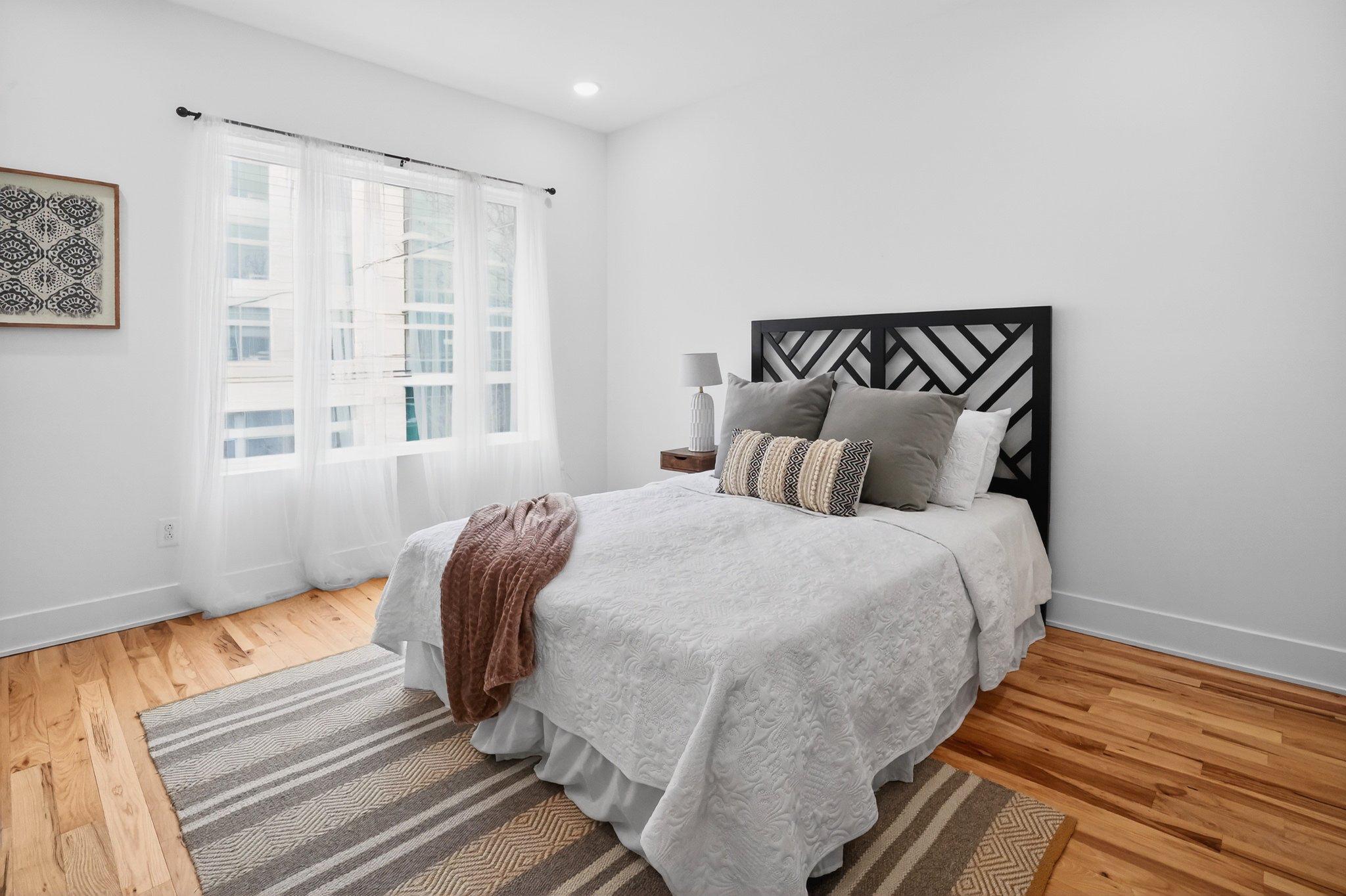1314 South 46th Street Philadelphia, PA 19143 - Photo 42 of 56 a bedroom with a bed and wooden floor