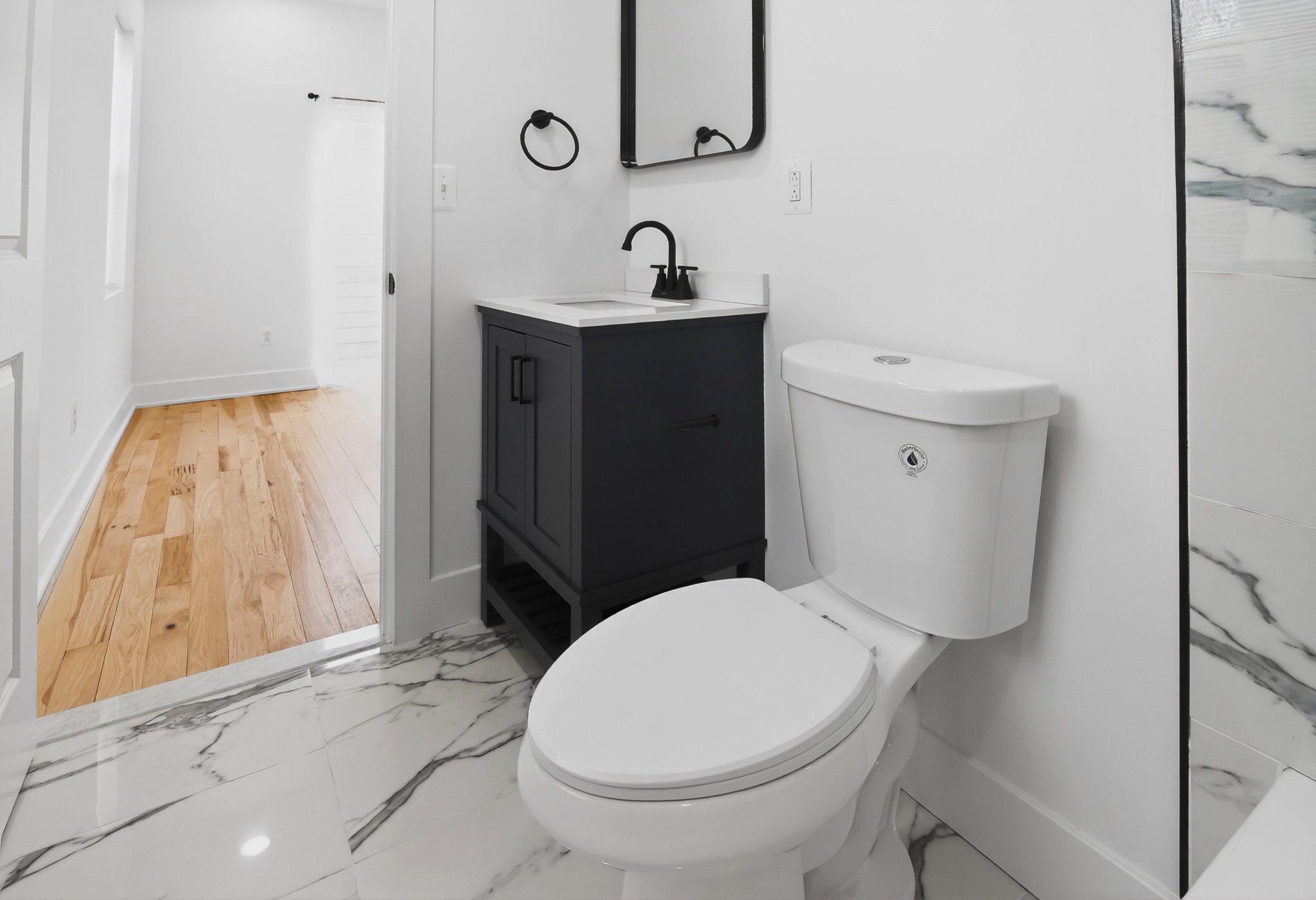 1314 South 46th Street Philadelphia, PA 19143 - Photo 48 of 56 a white toilet sitting next to a bathroom sink