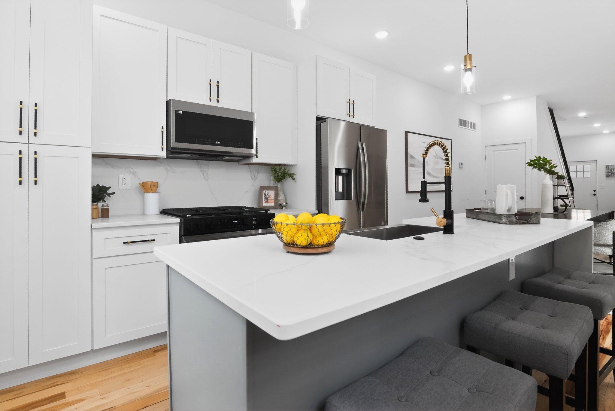1314 South 46th Street Philadelphia, PA 19143 - Photo 5 of 56 a kitchen with refrigerator and white cabinets
