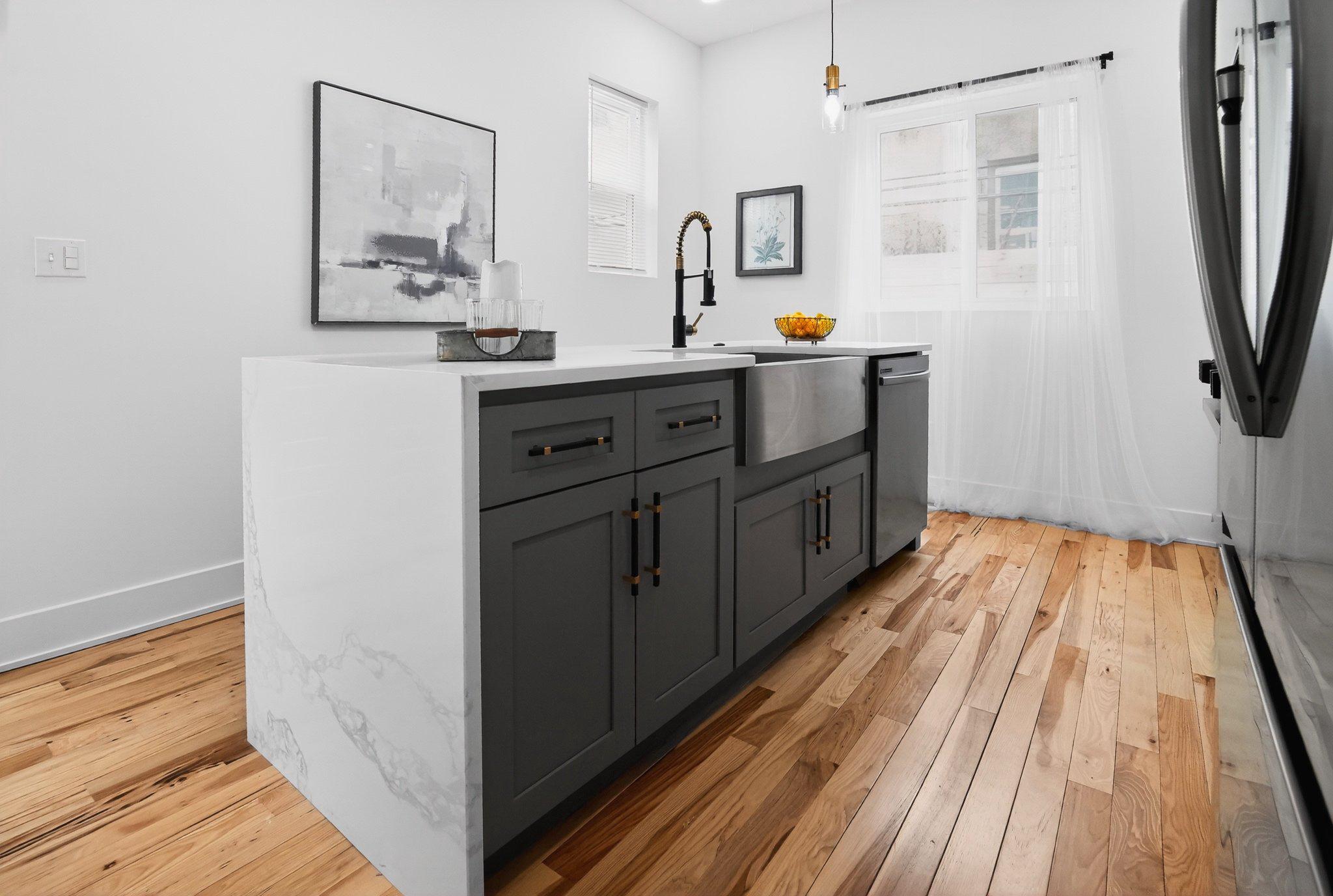 1314 South 46th Street Philadelphia, PA 19143 - Photo 6 of 56 a kitchen with a sink and wooden floor