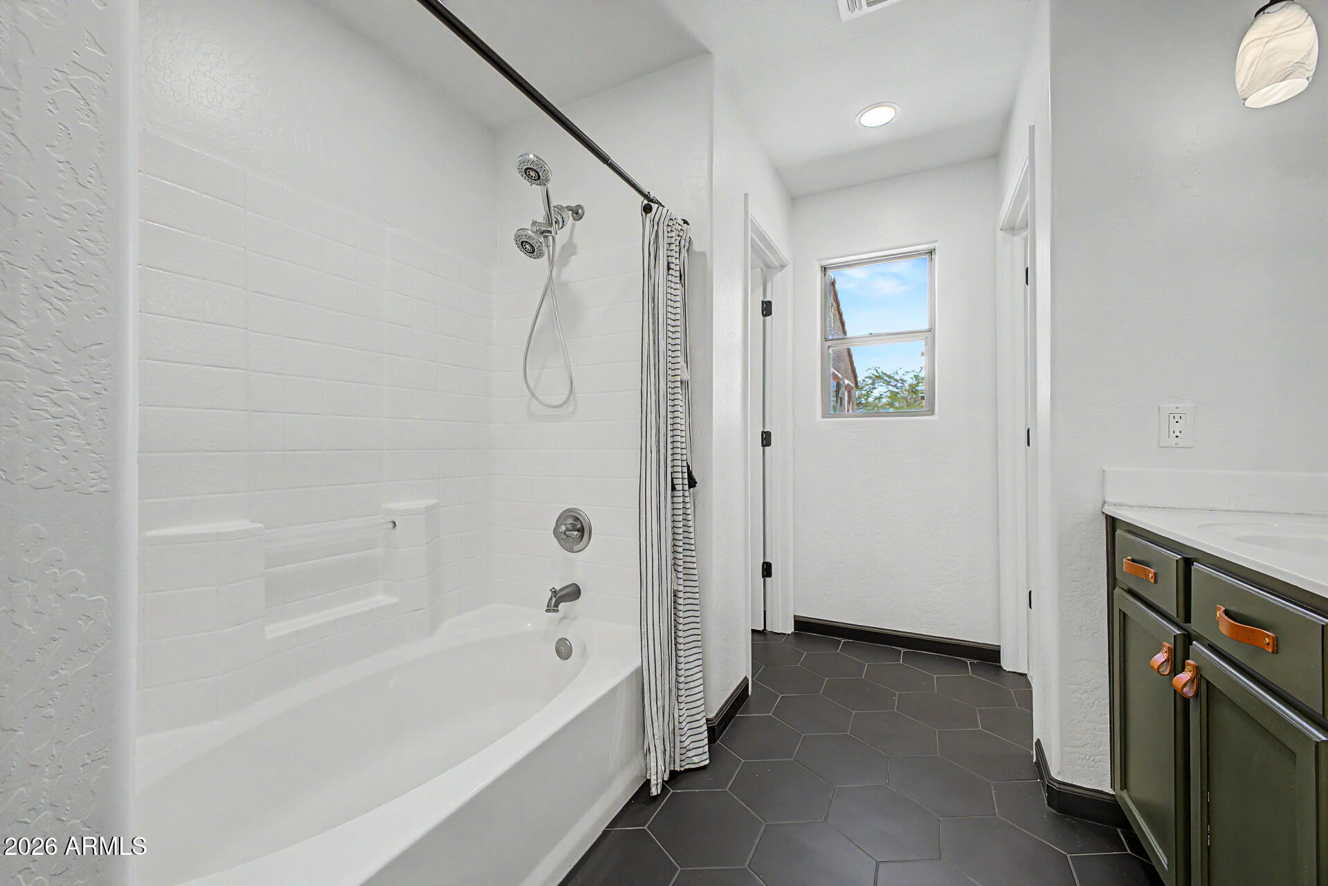 451 South Hawes Road, Unit 27 Mesa, AZ 85208 - Photo 16 of 27 a bathroom with a bathtub and a shower