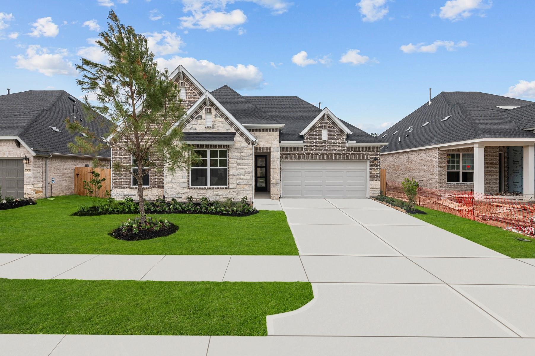 29626 Cedar Elm Way Tomball, TX 77375 - Photo 1 of 12 a front view of a house with a yard and garage
