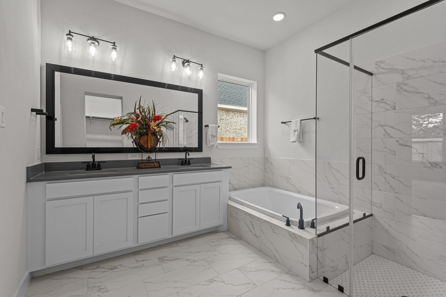 29626 Cedar Elm Way Tomball, TX 77375 - Photo 7 of 12 a bathroom with a tub a sink and mirror