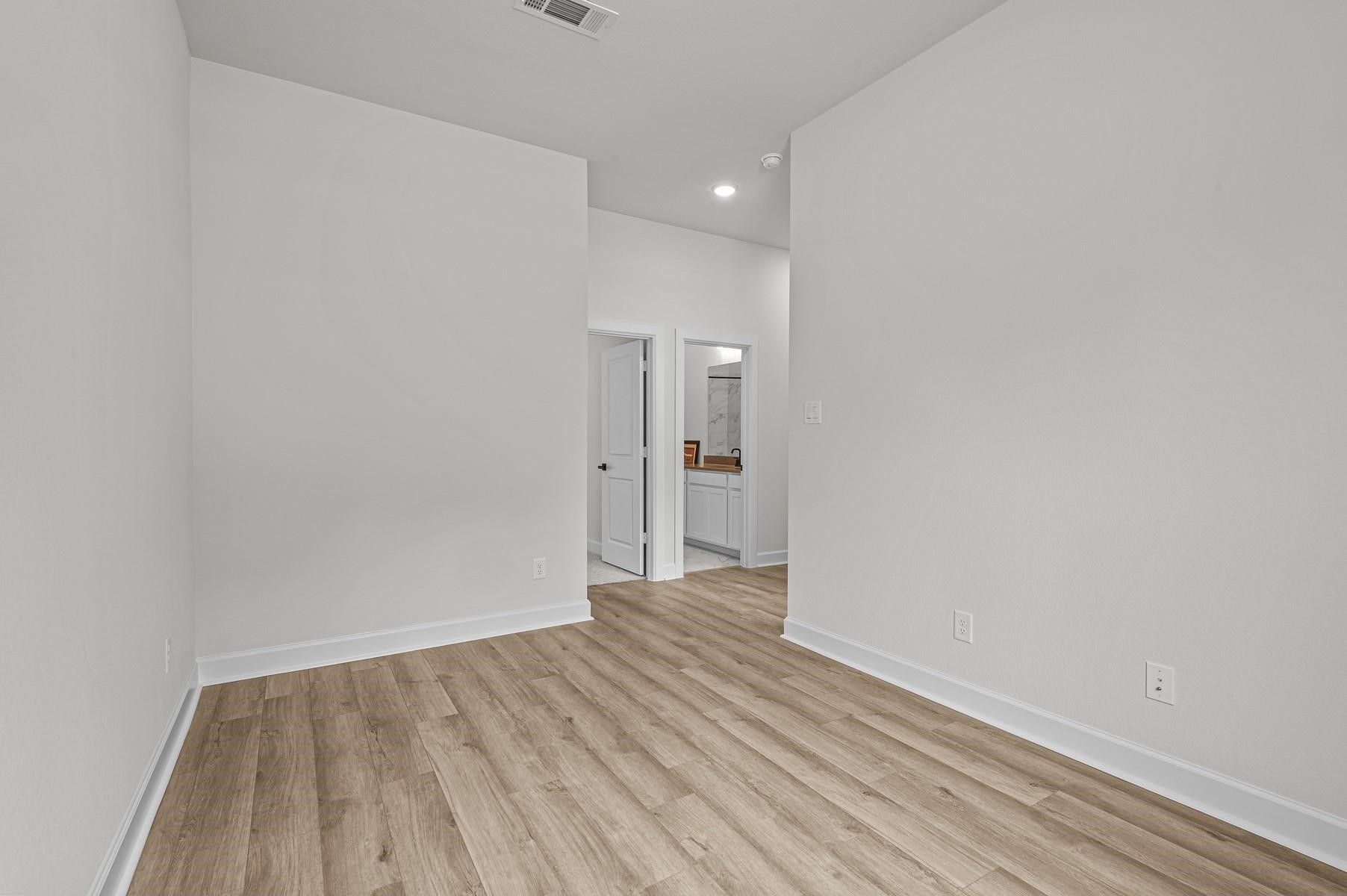 29626 Cedar Elm Way Tomball, TX 77375 - Photo 10 of 12 a view of an empty room with wooden floor and a window