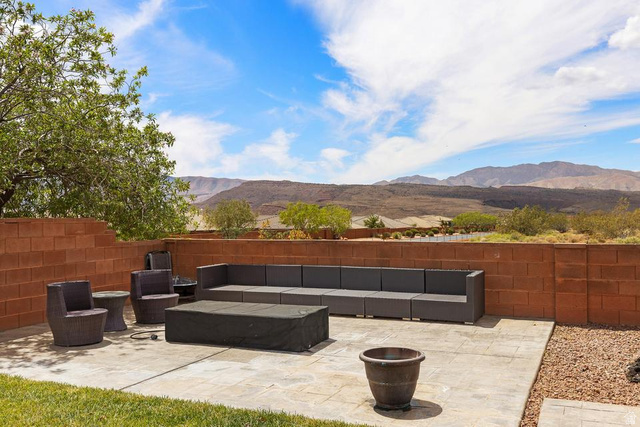 225 Falcon Court Ivins, UT 84738 - Photo 27 of 47 Fenced backyard featuring an outdoor lounge area, a patio, and a mountain view