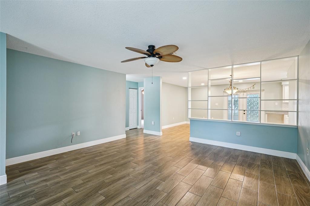 1118 Carlton Road Tarpon Springs, FL 34689 - Photo 13 of 62 wooden floor in an empty room with a window