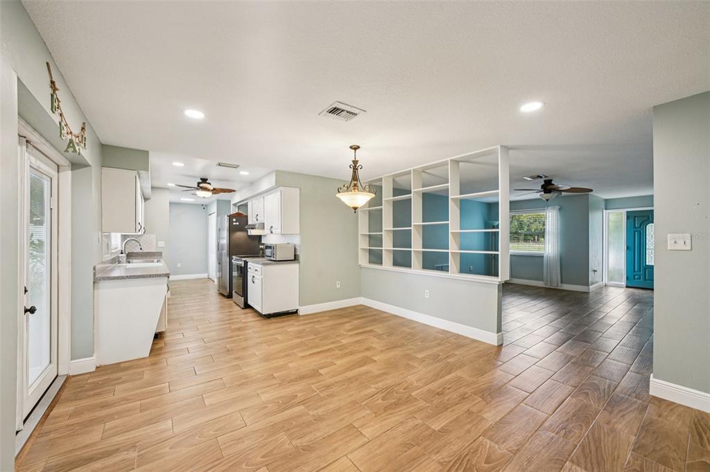 1118 Carlton Road Tarpon Springs, FL 34689 - Photo 16 of 62 a view of an empty room with kitchen and a window
